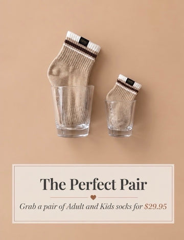 Two pairs of socks in glass cups on a beige background with promotional text.