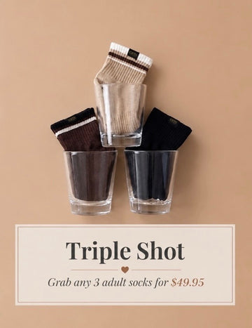 Three pairs of socks in clear glasses on a beige background with promotional text.