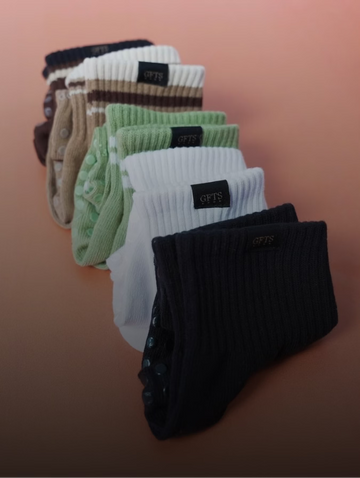 Set of colorful socks arranged in a row on a gradient background